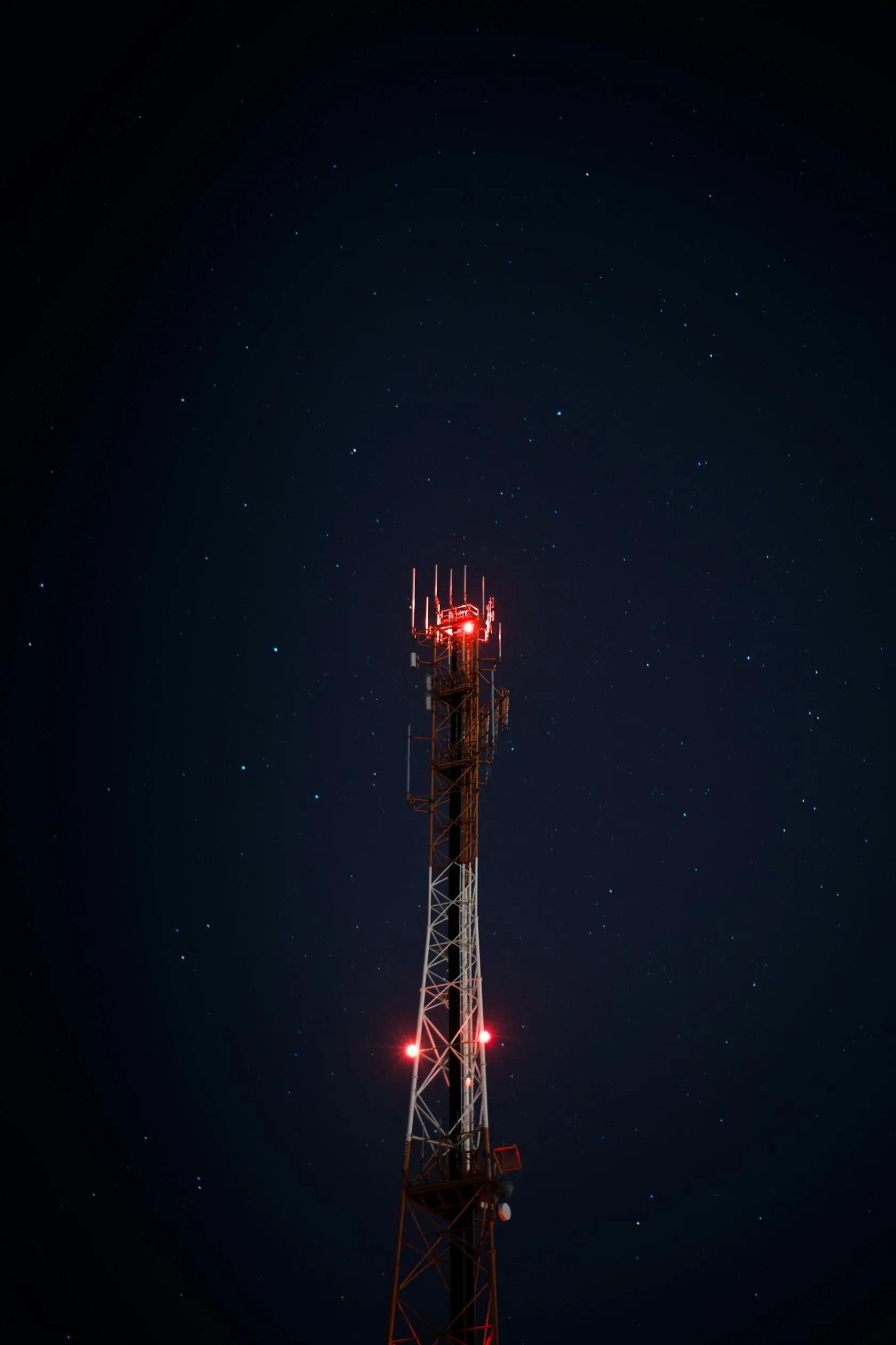 A telecom mast under a night sky